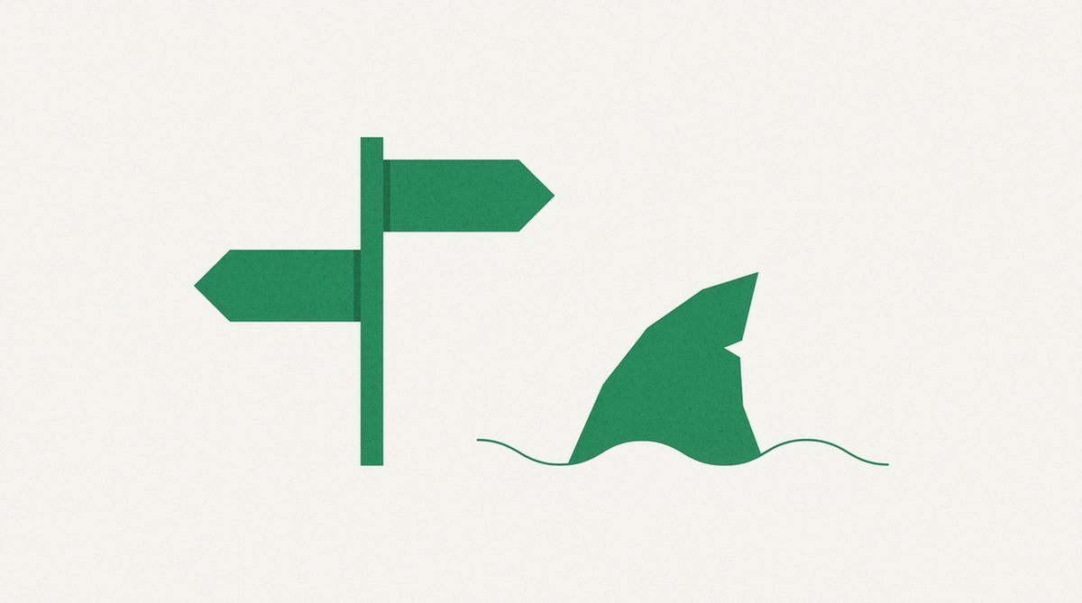 Forked signpost beside a stylized shark fin silhouette